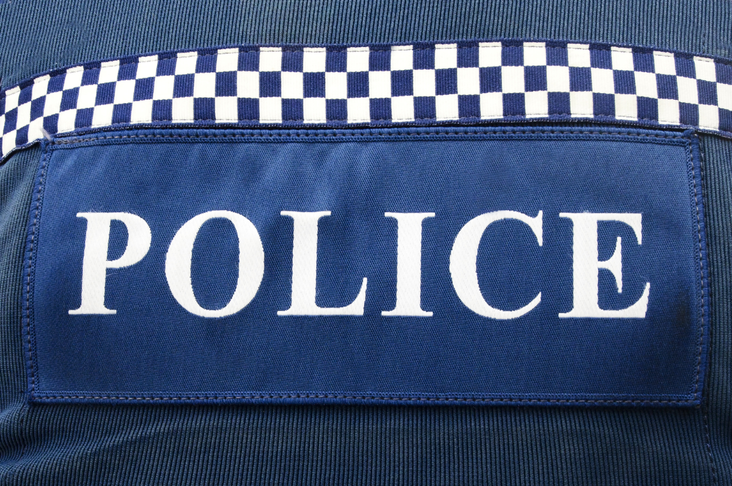 Close-up of NZ Police logo on police uniform.